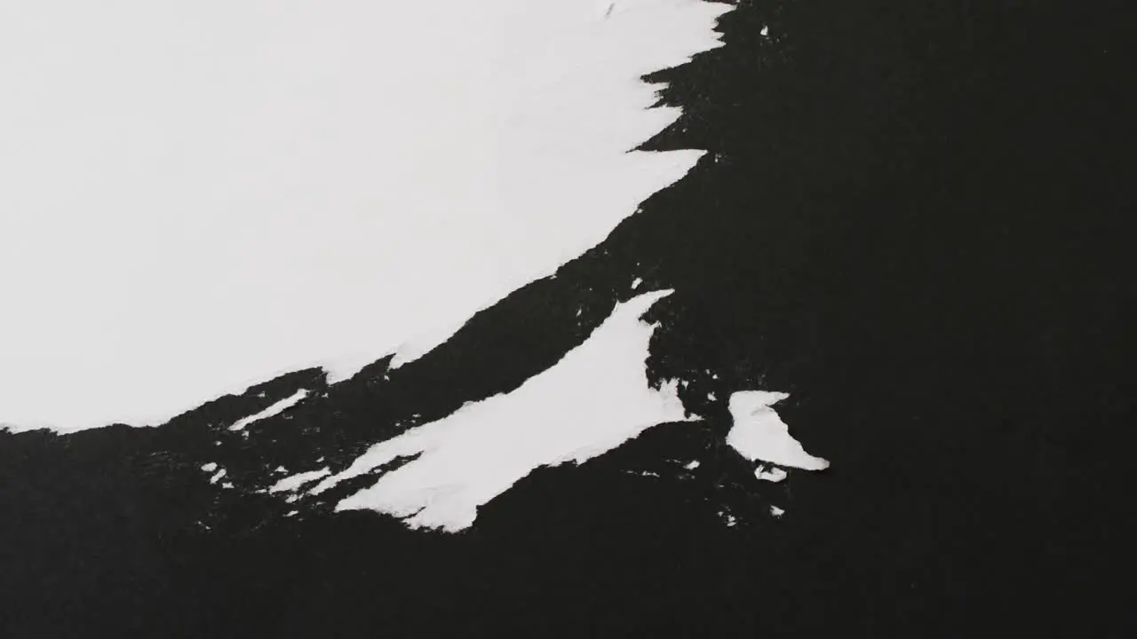 Video of close up of strokes of black paint on white background