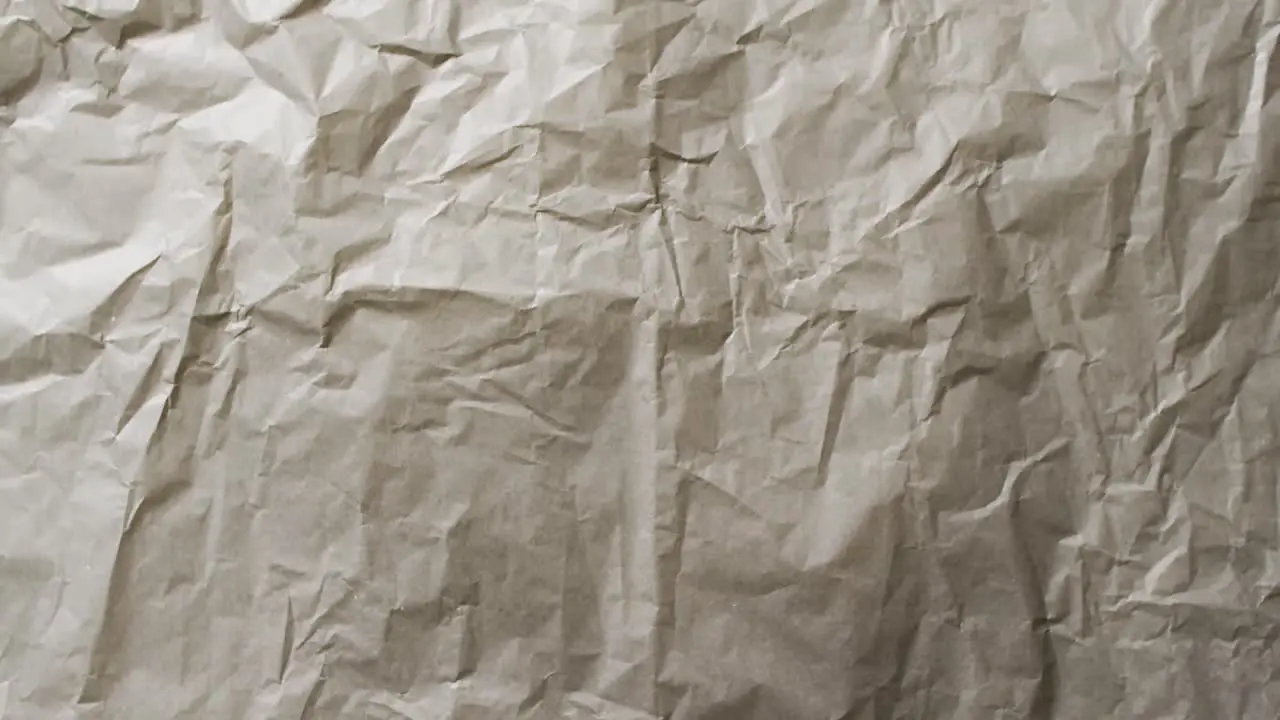 Video of close up of crumpled grey paper texture background