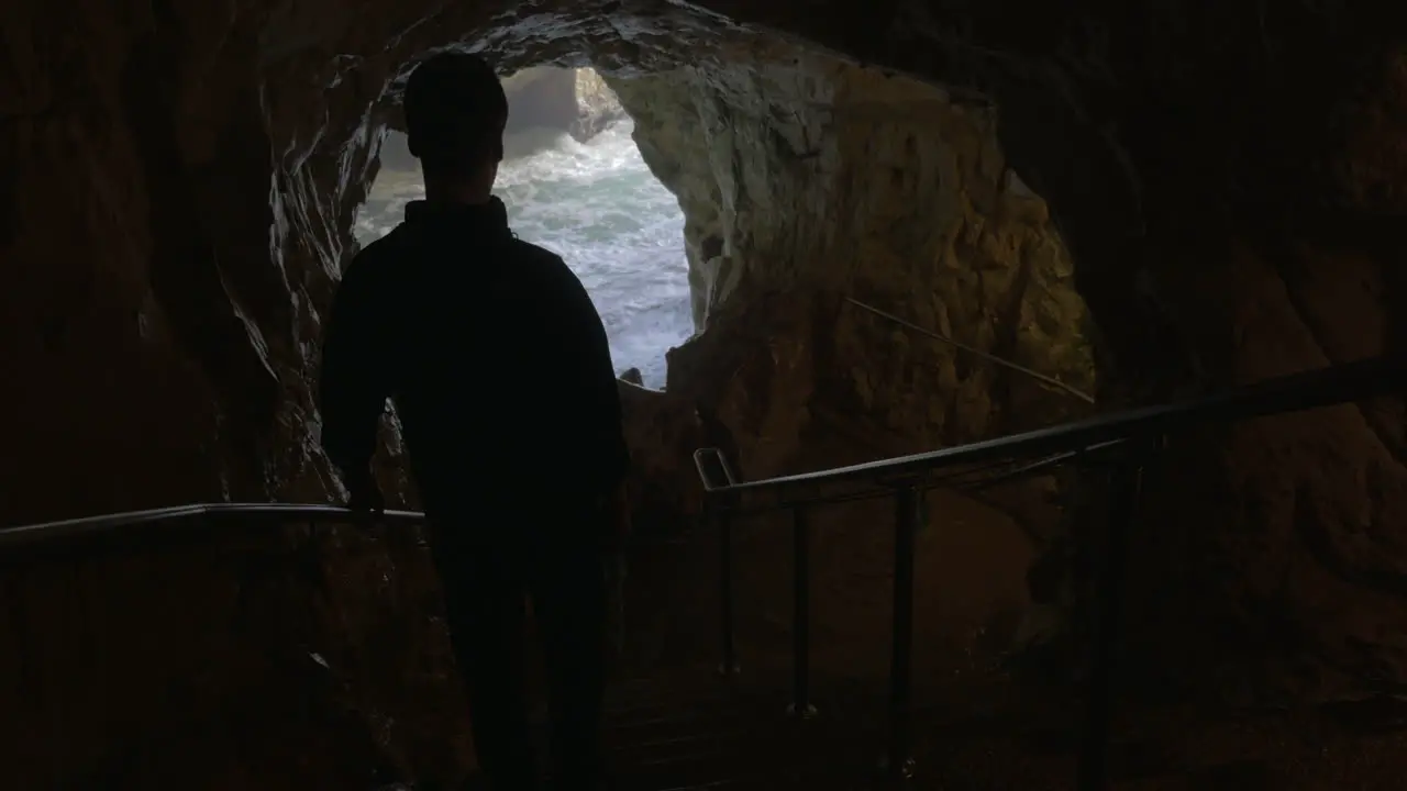 Tourist admiring the beauty of sea caves in Rosh Hanikra