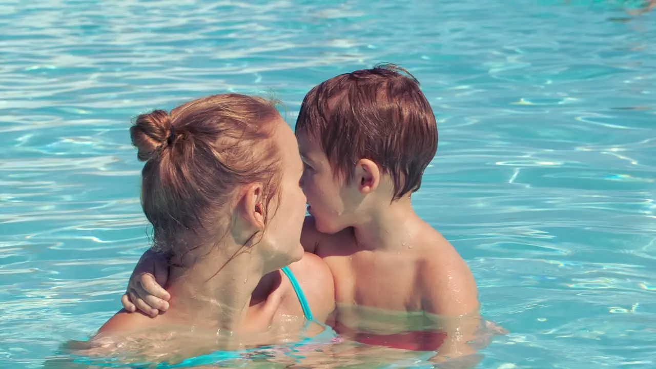 Mother and her son in the outdoor swimming pool