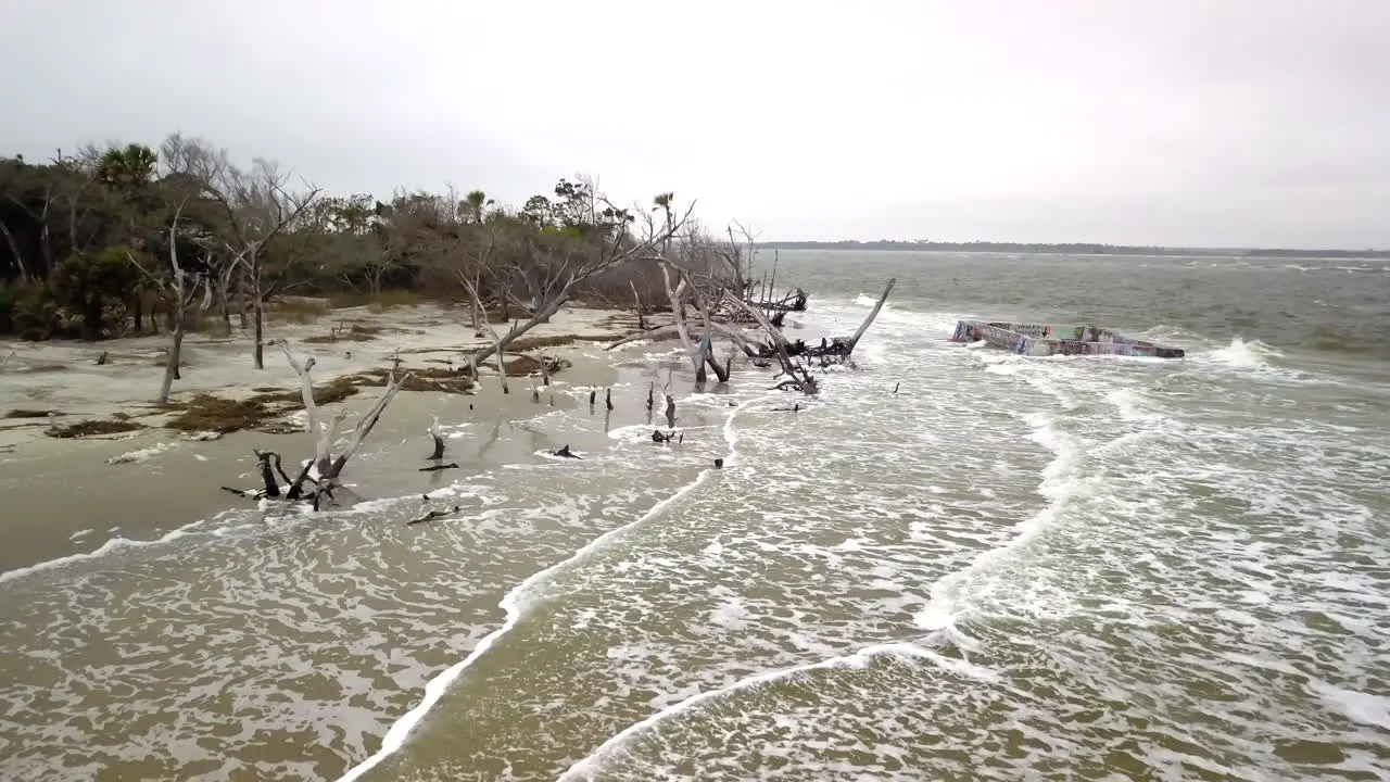 Aerial flying over waves as they roll into Folly Beach on the coast of South Carolina