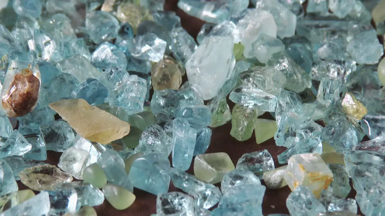 A gemologist sorting through a parcel of Aquamarine rough close up