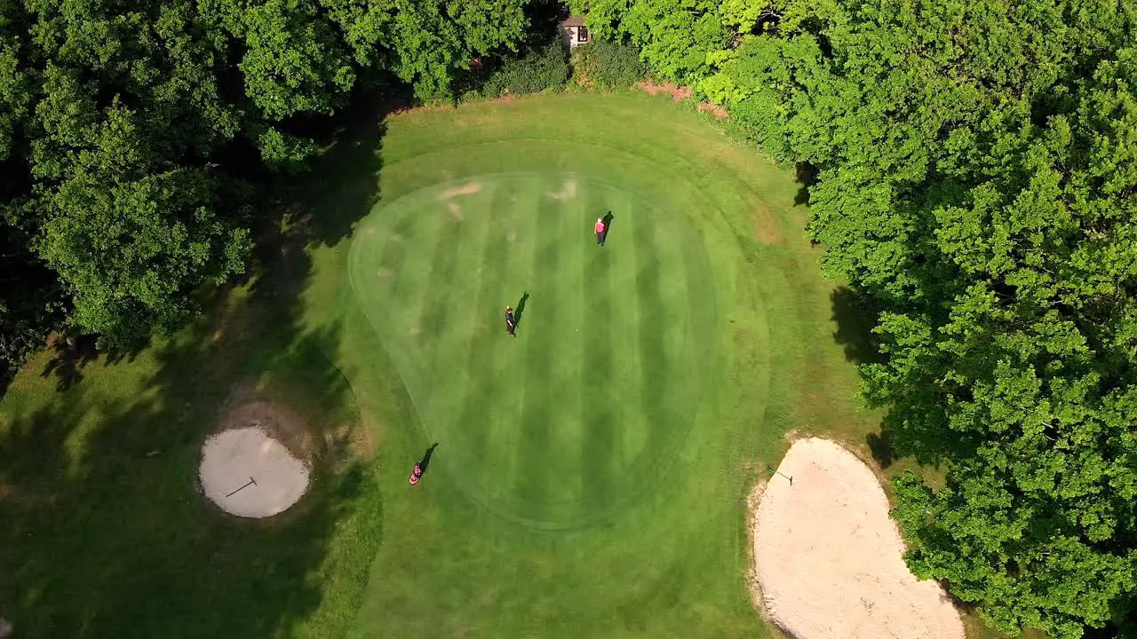 Aerial Crane Shot over Golf Green with Bunkers and Beautiful Dappled Lighting