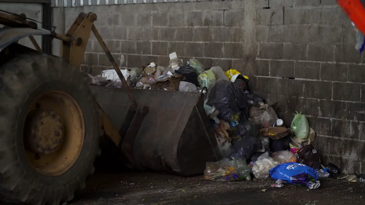 A bulldozer loads waste onto the bucket