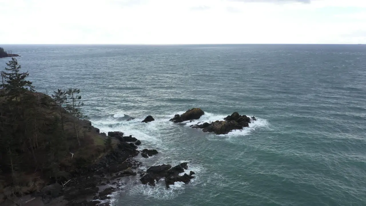 Still aerial view of moderate waters beating against rocks in the middle of the ocean