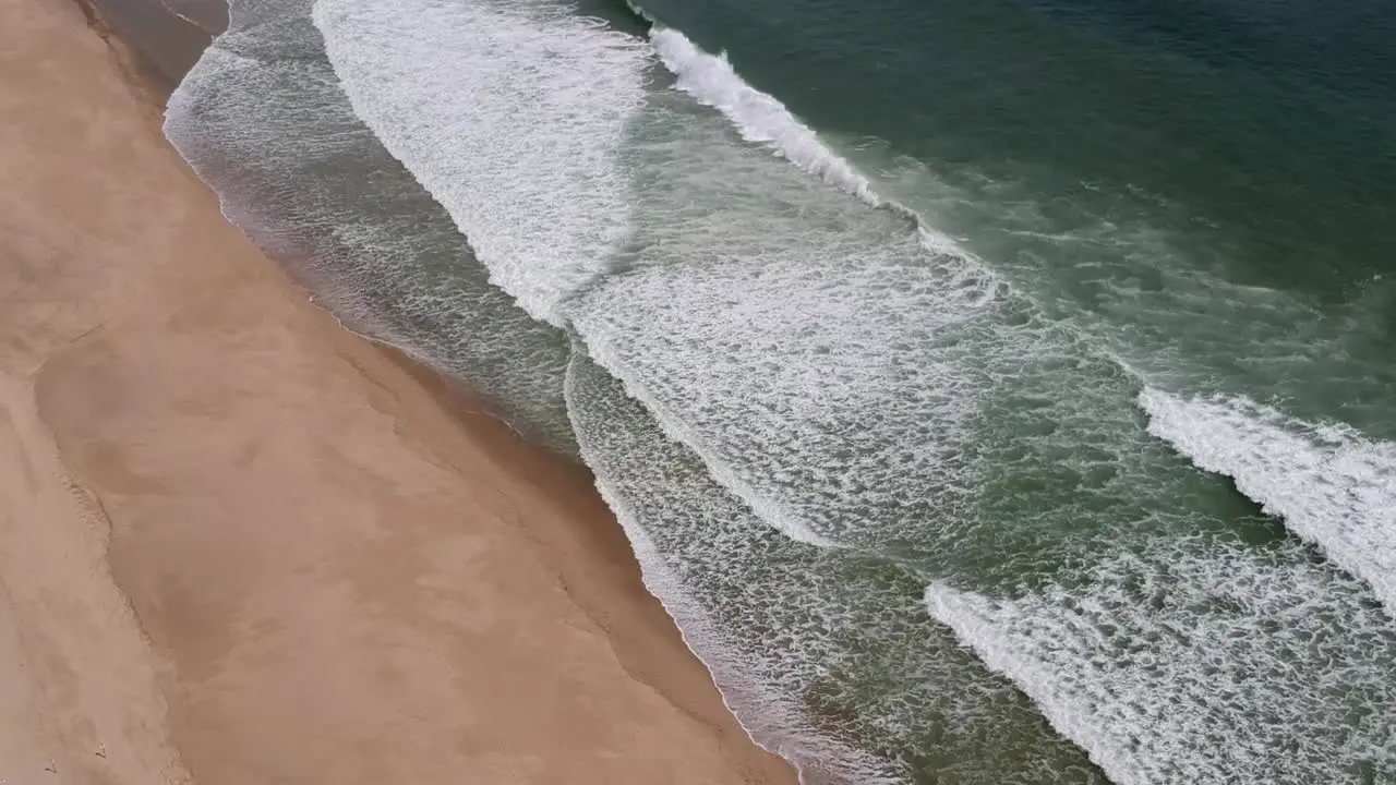 Drone Aerial Panning Shot Rough Waves Crashing Along Shoreline on Cape Cod Beach