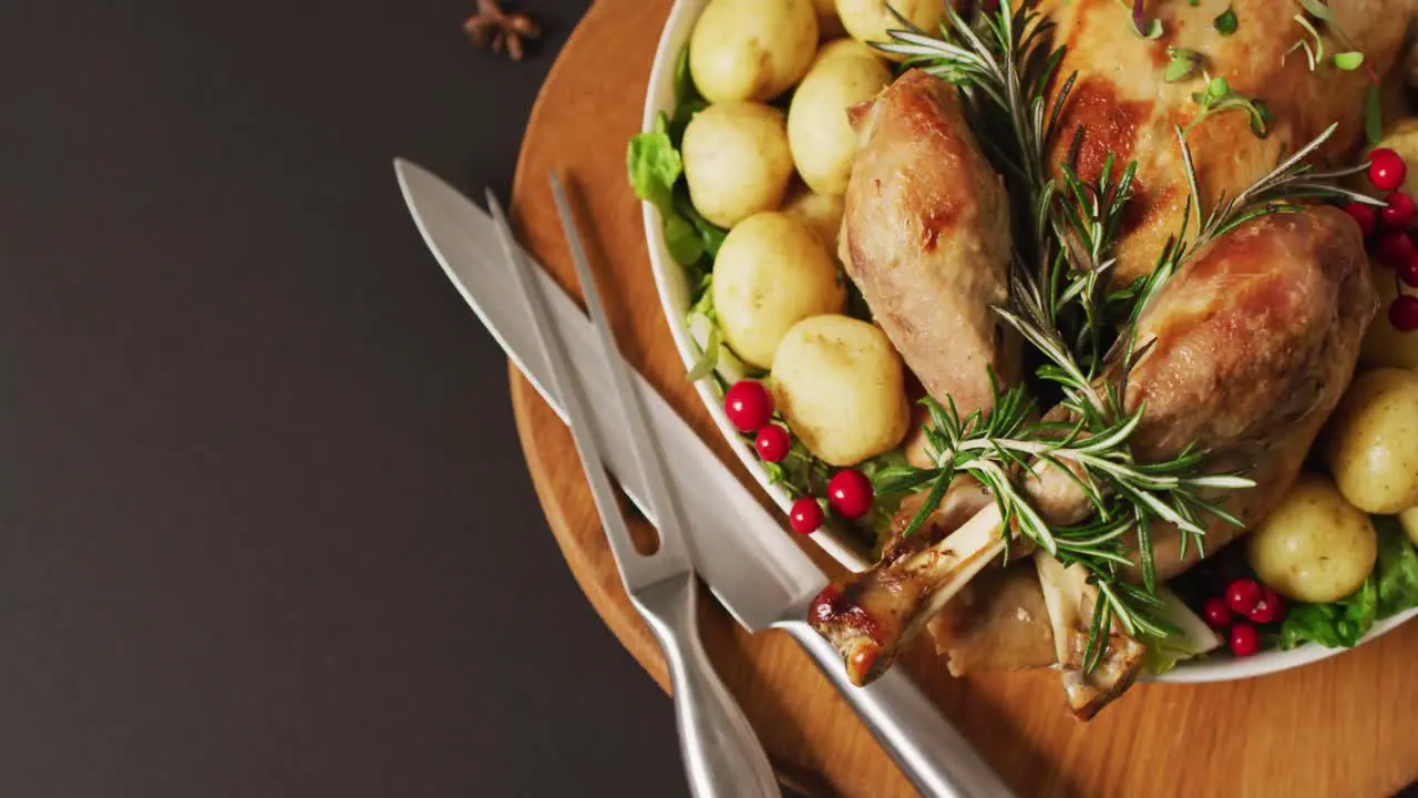 Video of tray with roasted turkey potatoes and cutlery on grey surface