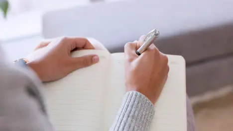 Woman hands writing in notebook