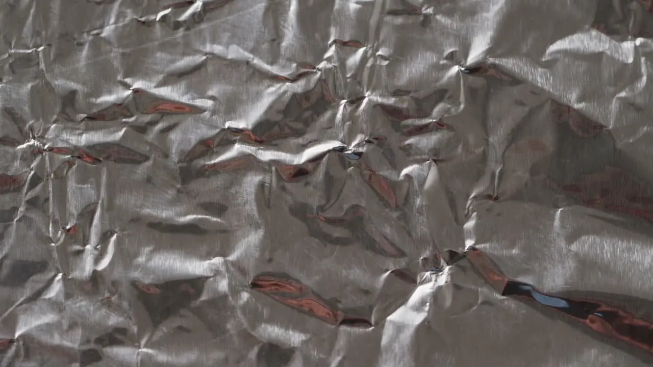 Close up of gray crumpled piece of paper in slow motion