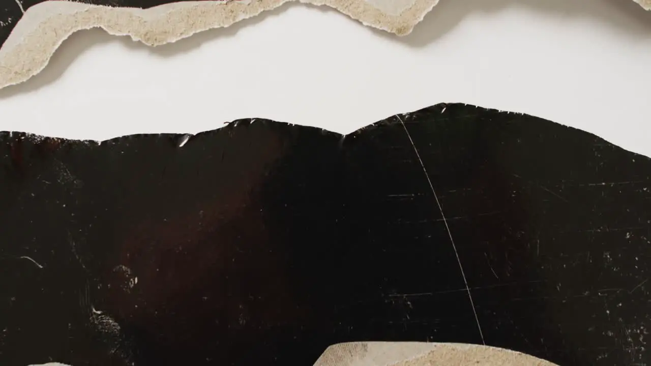 Video of close up of torn paper on black and white background