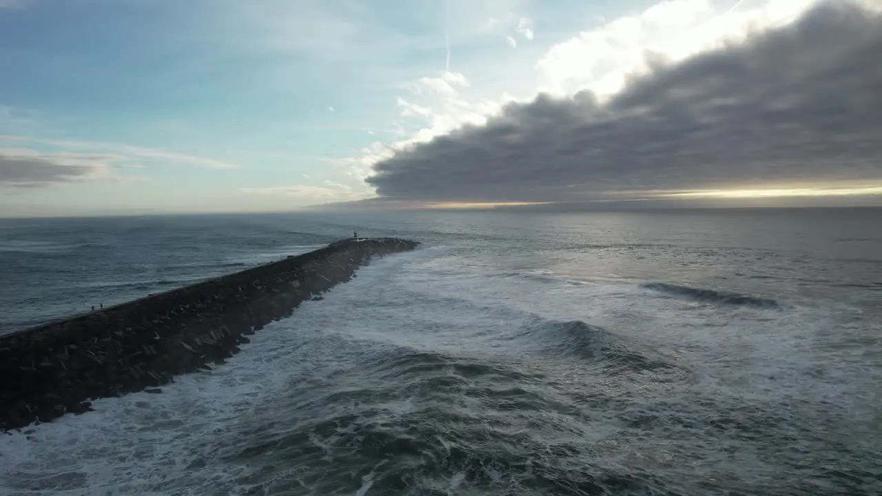 large waves crashing on Rocks at sunset