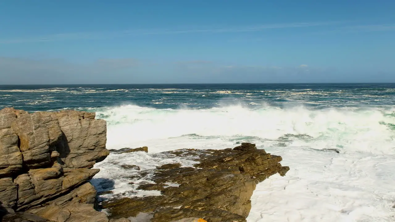 Wave crash into rocks with big white splash rugged Atlantic coastline