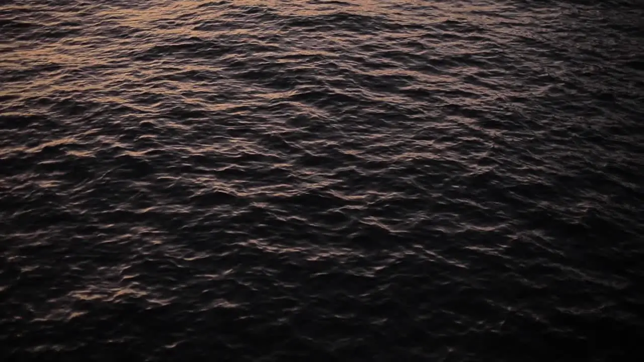 Sunset light reflecting on the water surface of the sea lake