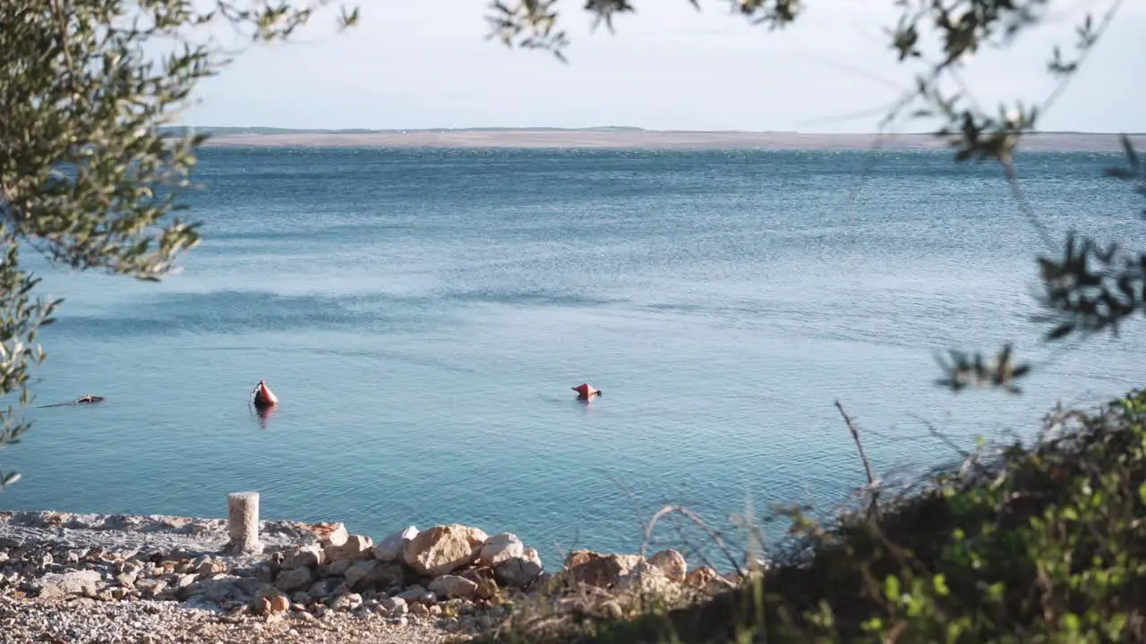 Buoys floating in shallow coastal water beautiful remote Croatian bay