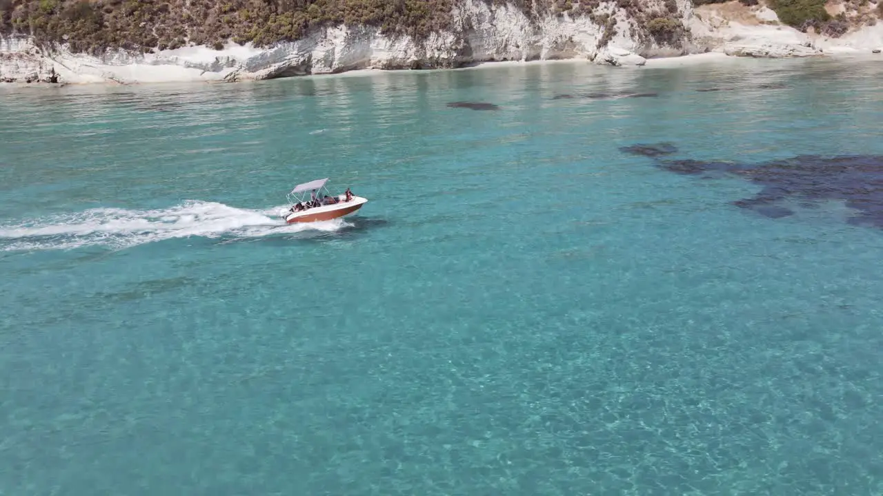 Chasing the boat ont the water with turquoise clear water in Zakynthos Greece