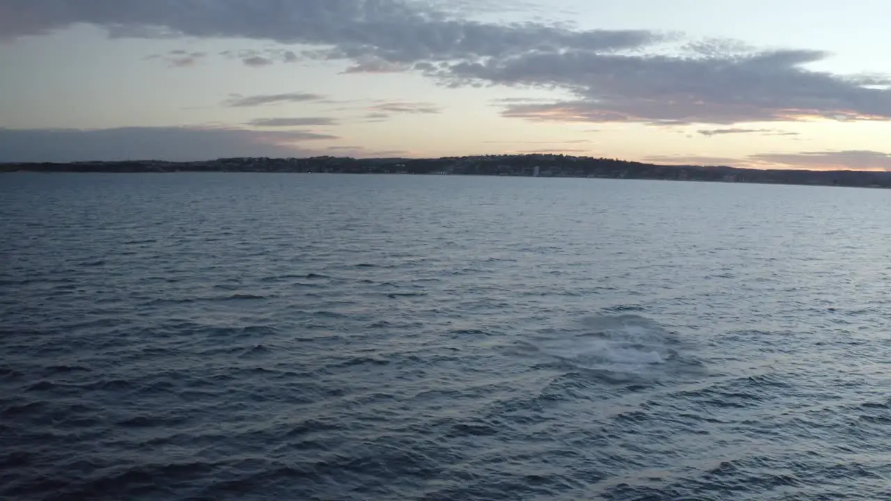 Whale watching off Sydney Northern Beaches Coastline during sunset Aerial drone footage of Humpback Whale breaching and playing around during migration