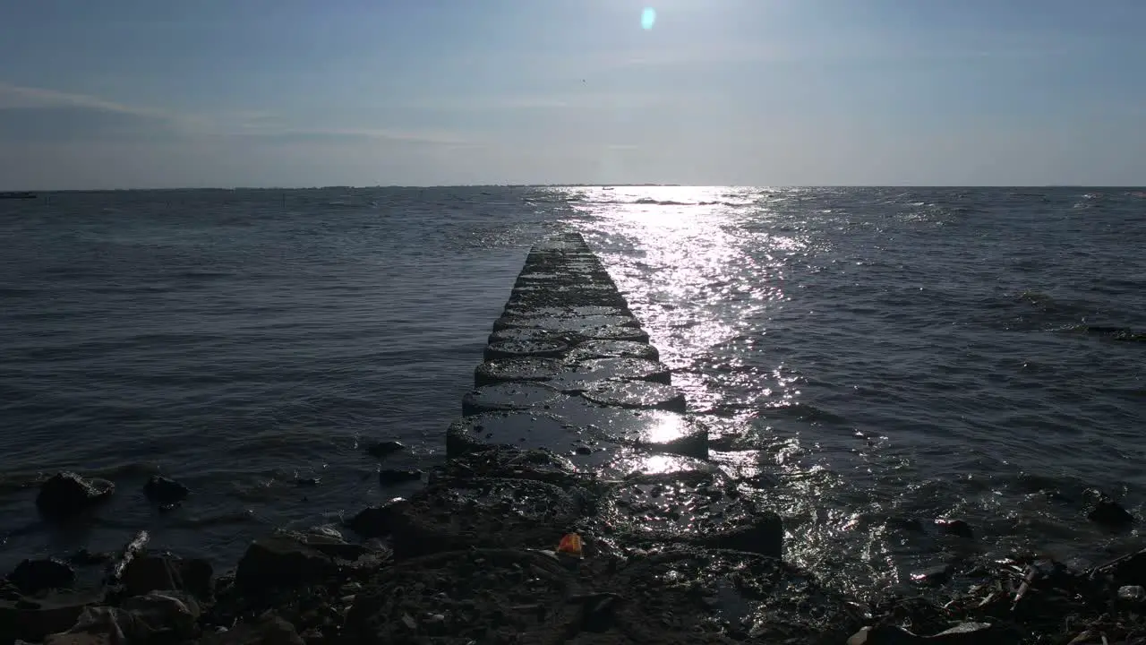 stone road that leads to the middle of the sea