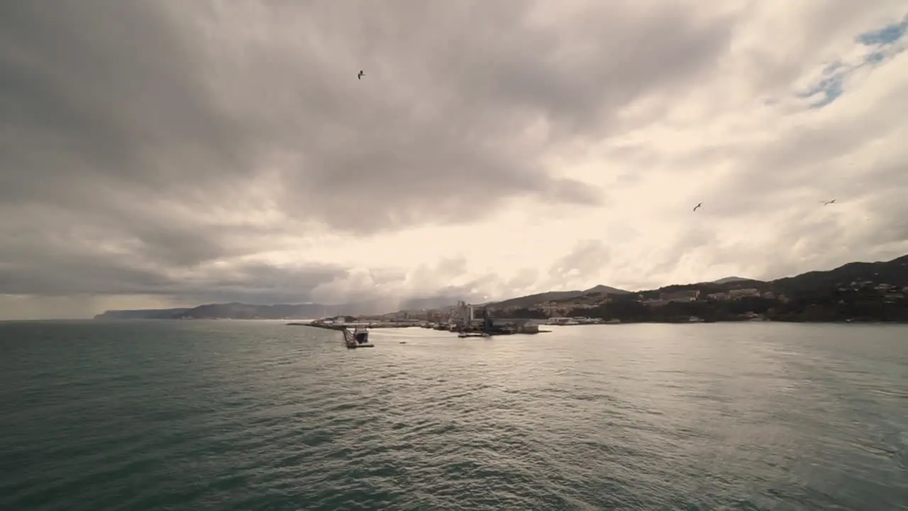 Cruise ship leaving the beautiful italian harbour of Savona with seagulls flying around