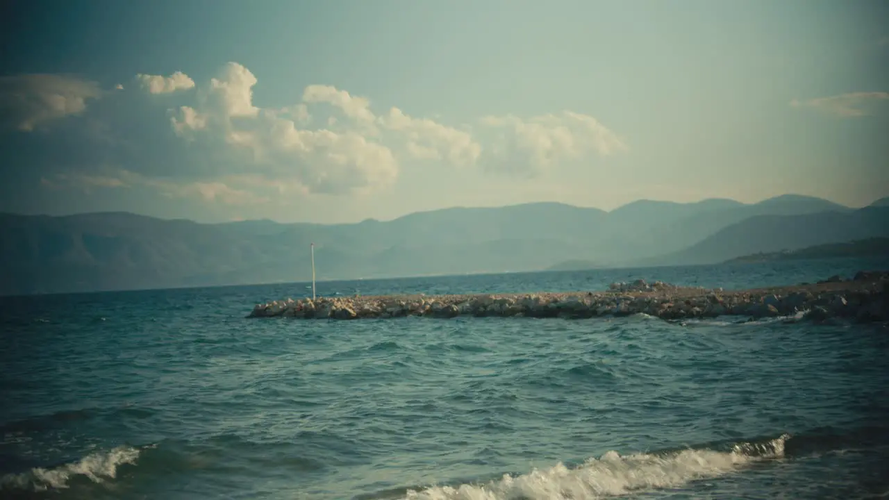 View of the island sea with a pier and windy waves