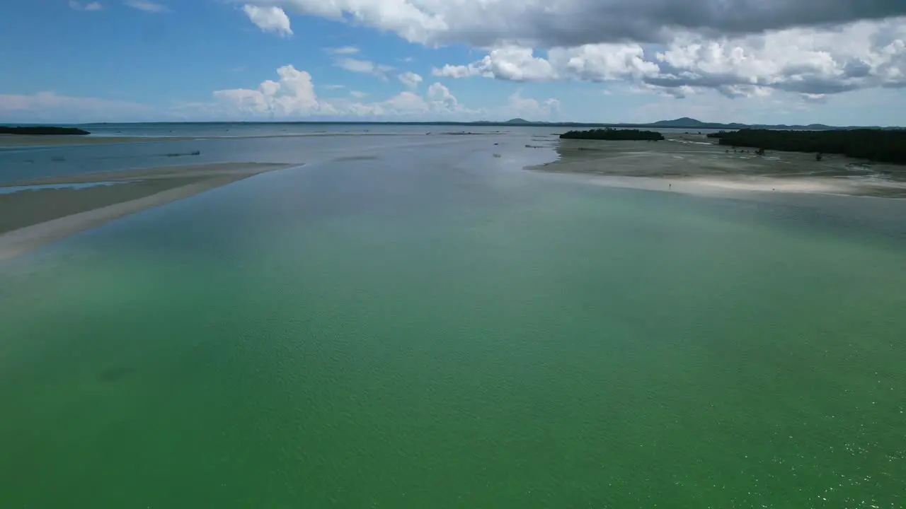 Indonesian boat cruising in tropical emerald green ocean