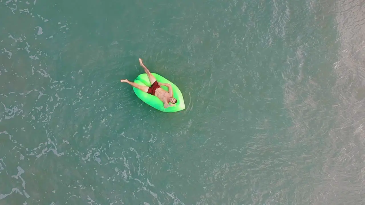 Man relaxing in turqoise water in the Philippines on vacation