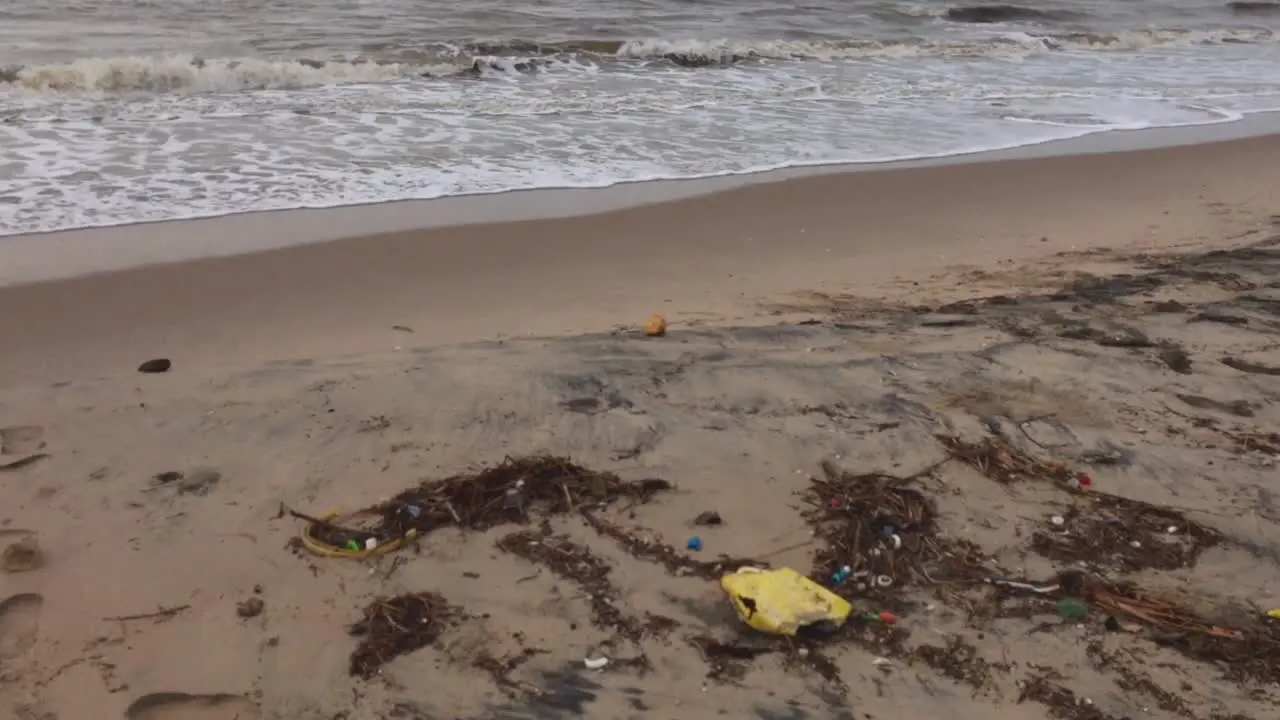 Drift trash on a polluted sandy beach