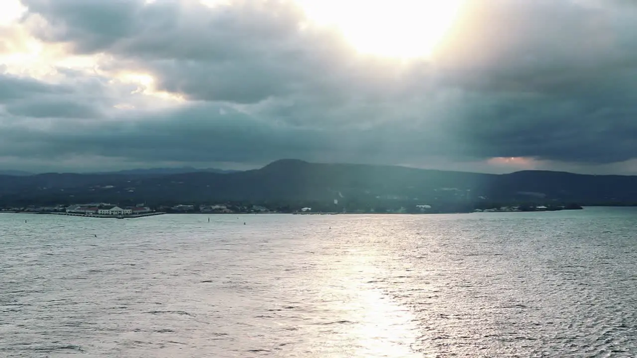 Time lapse view departing Kingston Jamaica at sunset on a cloudy summer evening