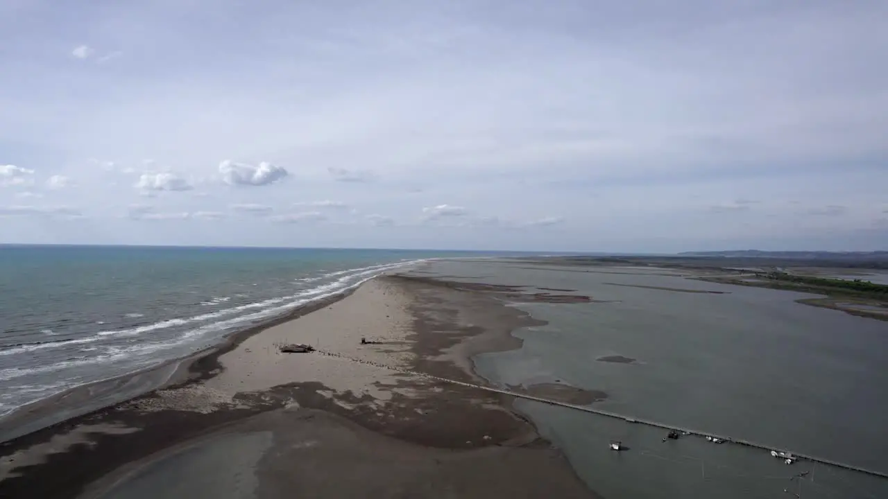 Drone video over the Divjake-Karavasta nature park Upward frontal shot advancing between the beach and the nature park leaving the sea to one side