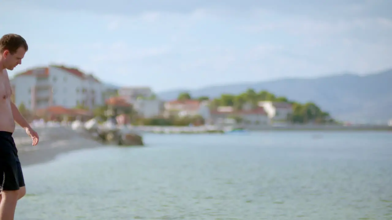 Young Man Tourist Walking On Sea Shore In Summer 1