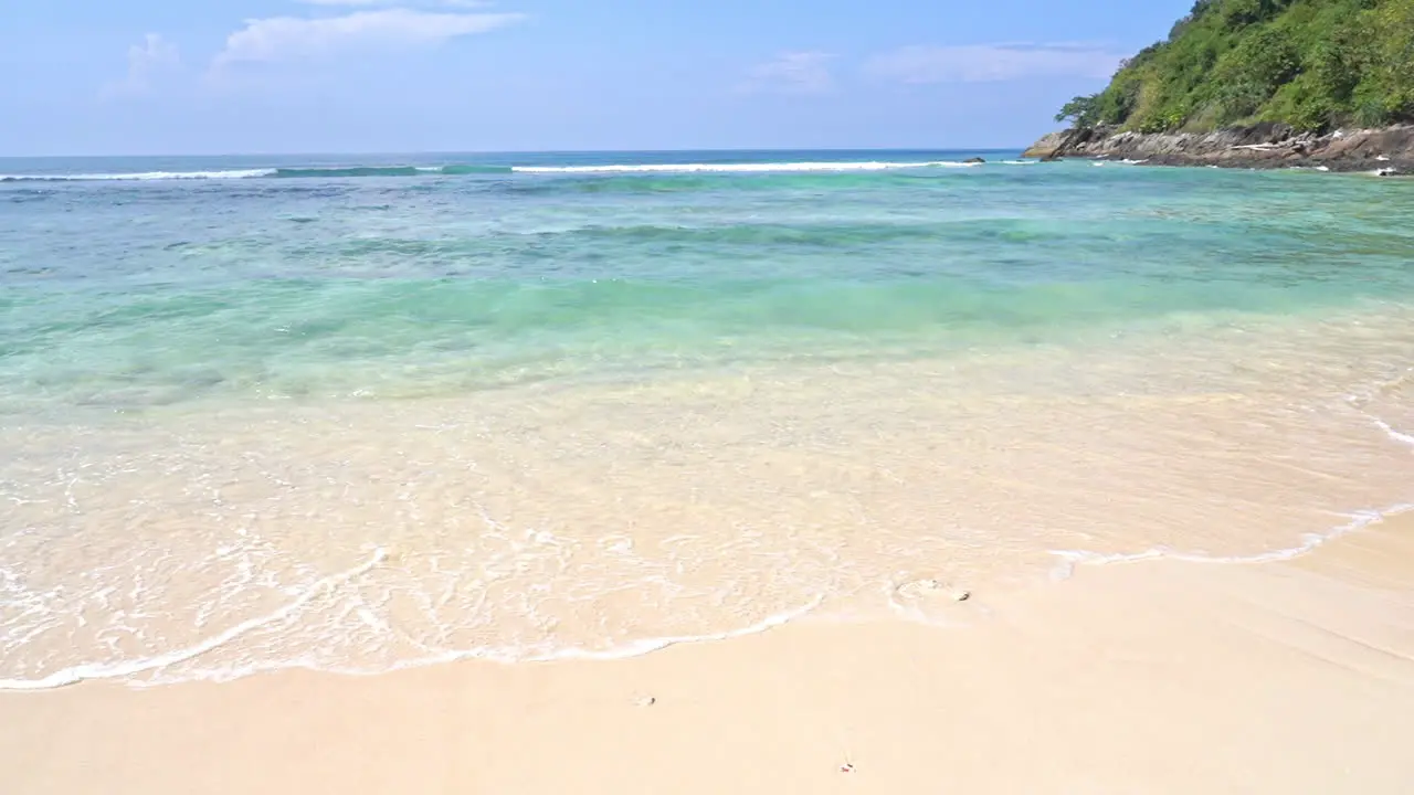 Slow-motion of waves washing over a sandy tropical beach