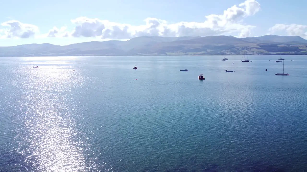 Snowdonia clear mountain range aerial view sunny calm Welsh shimmering seascape