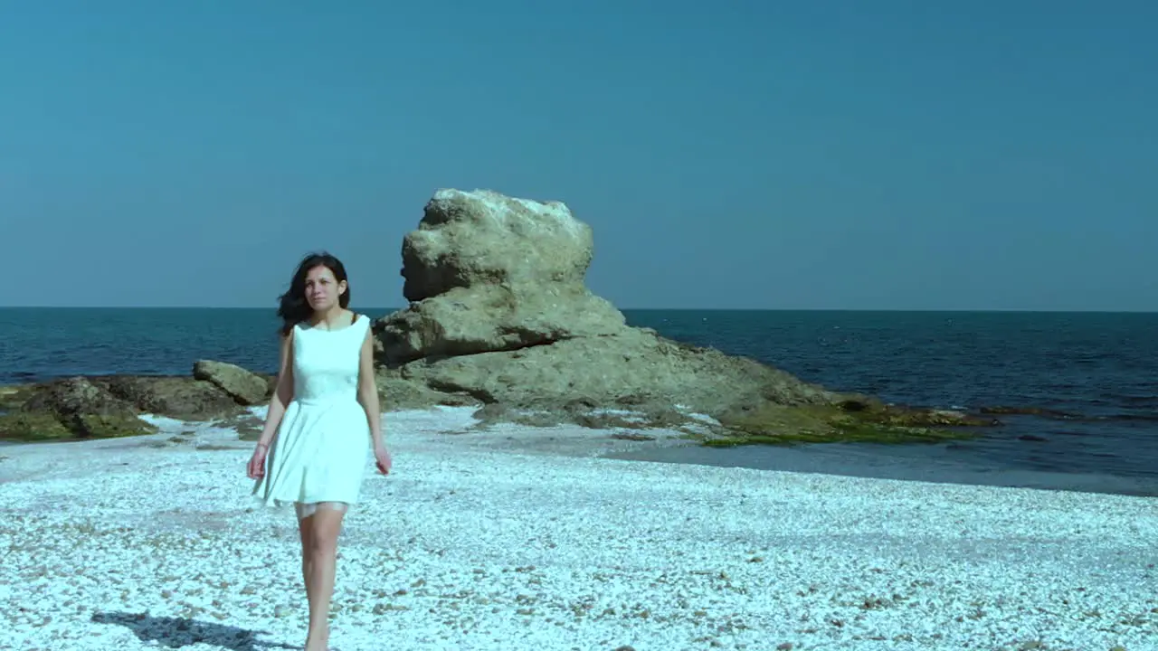 Pretty girl in white dress walk on the beach-3