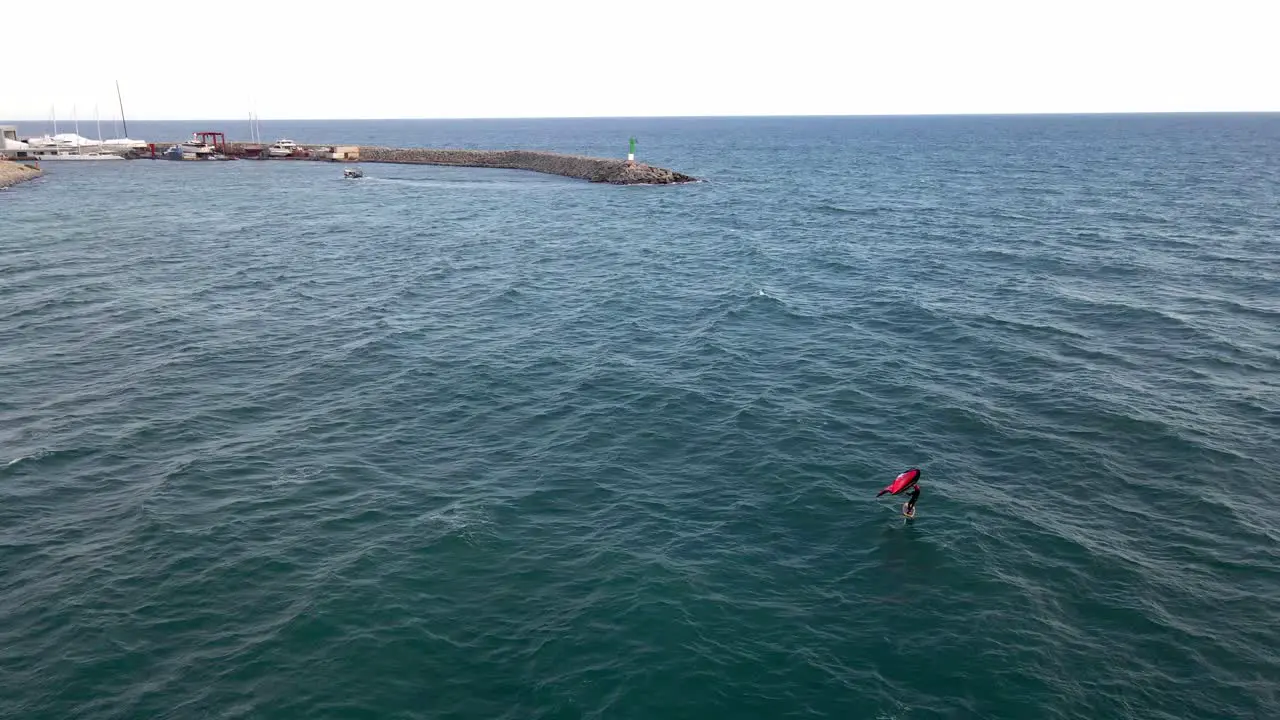 This is a 4k aerial shot of a person at the sea near to a bay