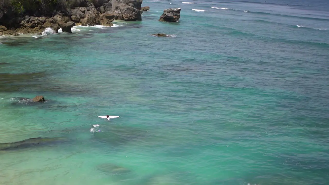 Surfer in the water in Uluwatu Bali