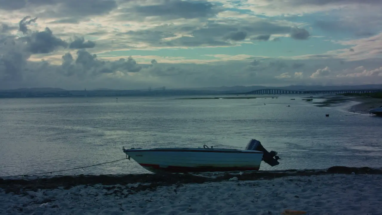 portuguese sea a boat on the sand during the sunset in Lisbon