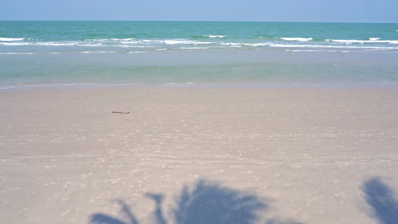 Wild White sand beach with no people small sea tides with foam slowly move towards beach line