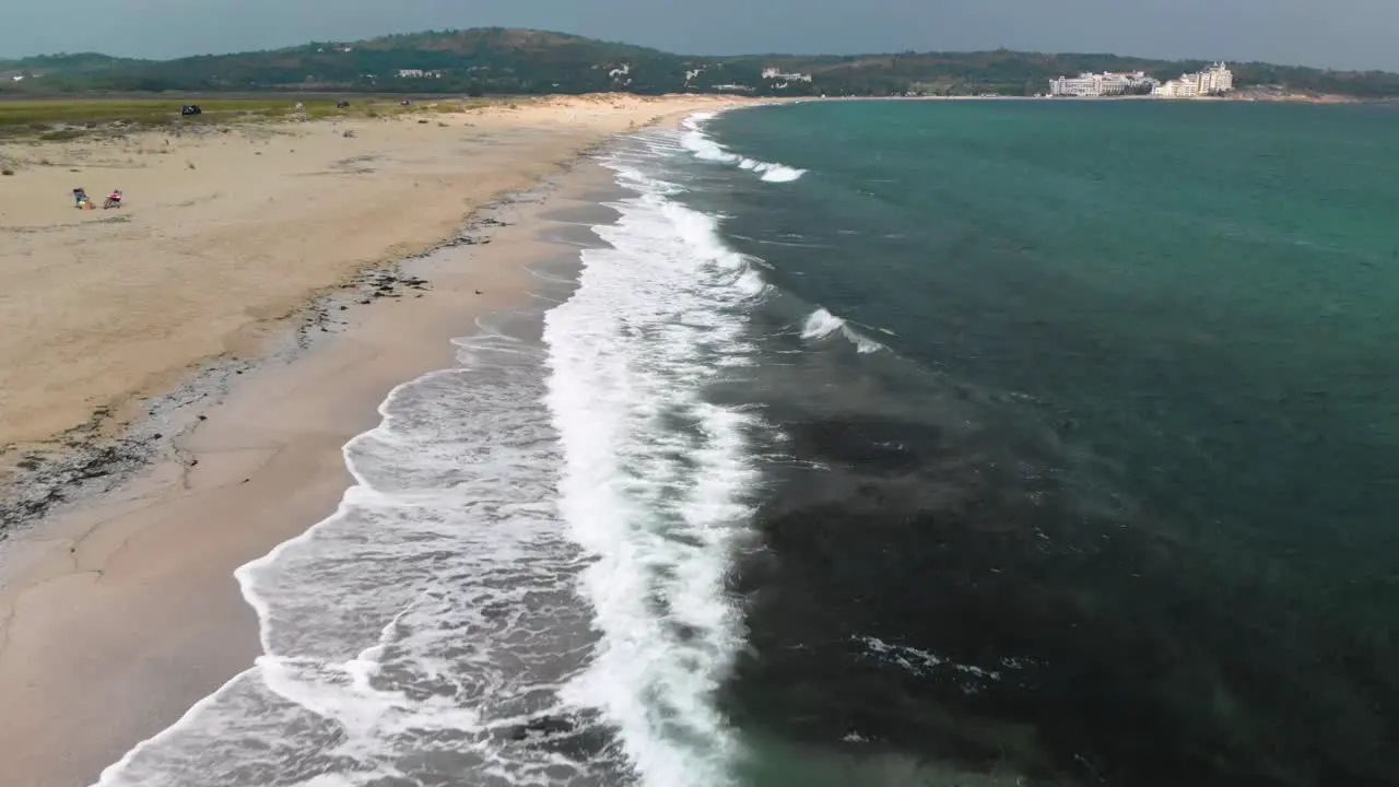 Aerial footage drone shoot parallel to sea shore flying above waves and seagulls Sozopol Bulgaria