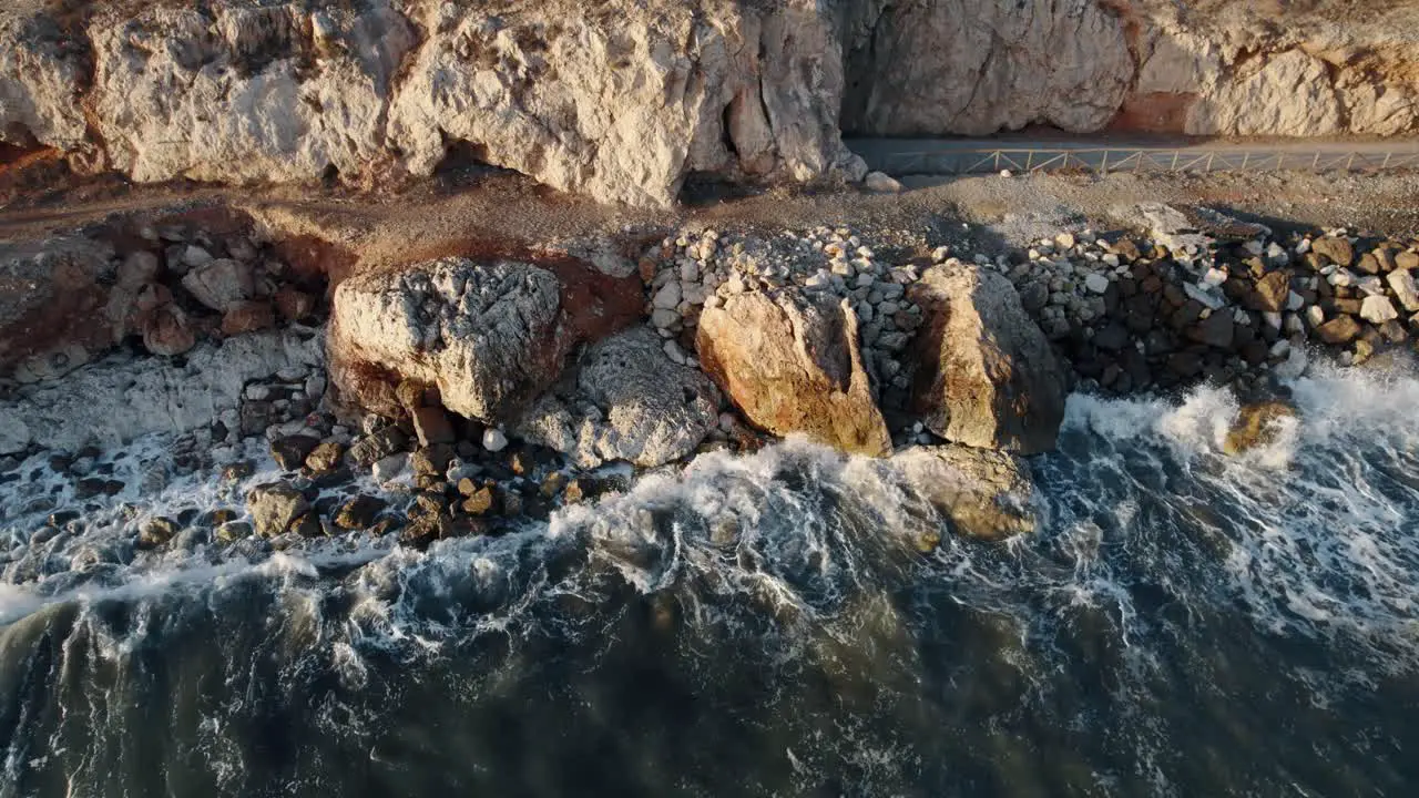 Bird s Eye Shot Of Small Waves Crashing On Rocks In Blue Sea Penon Mexico