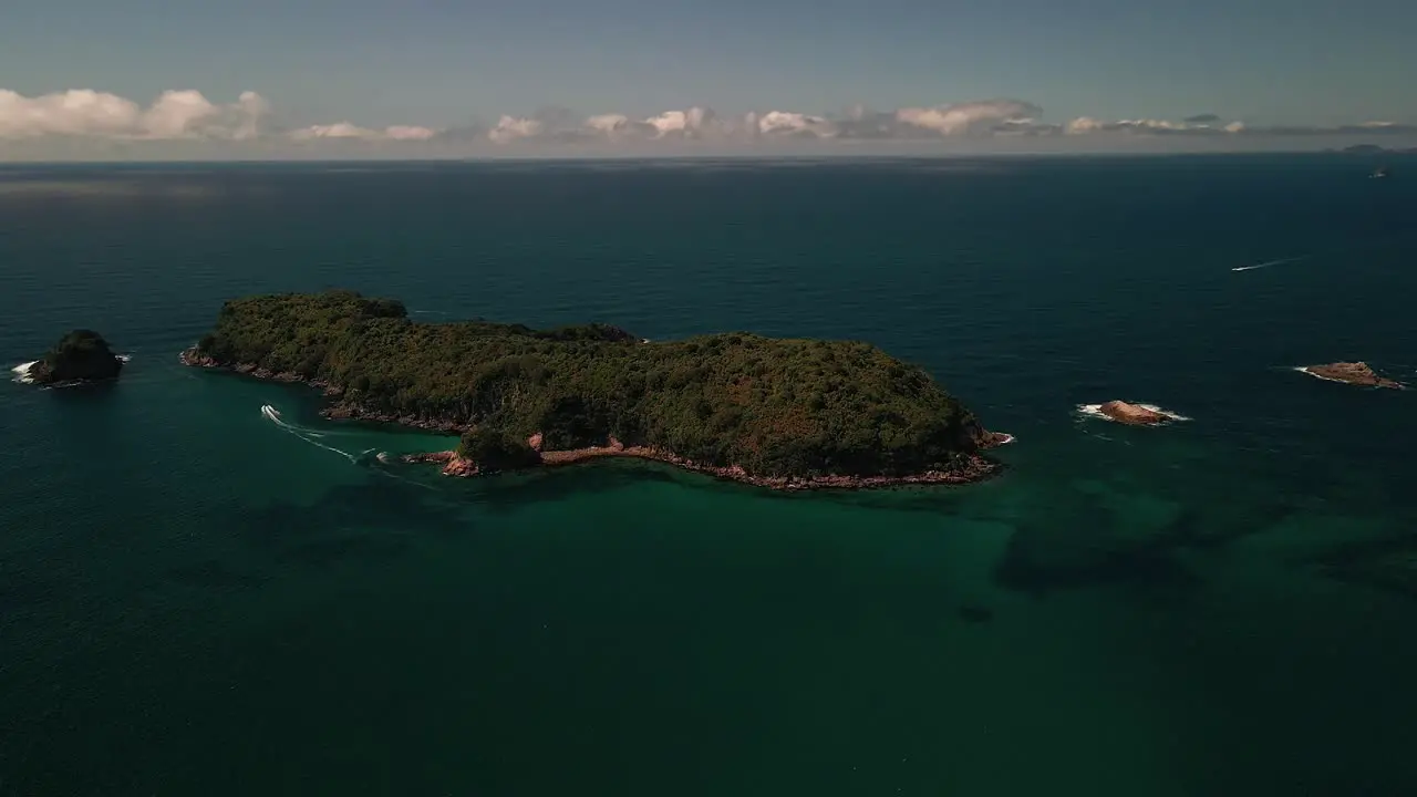 Boat driving around deserted tropical island