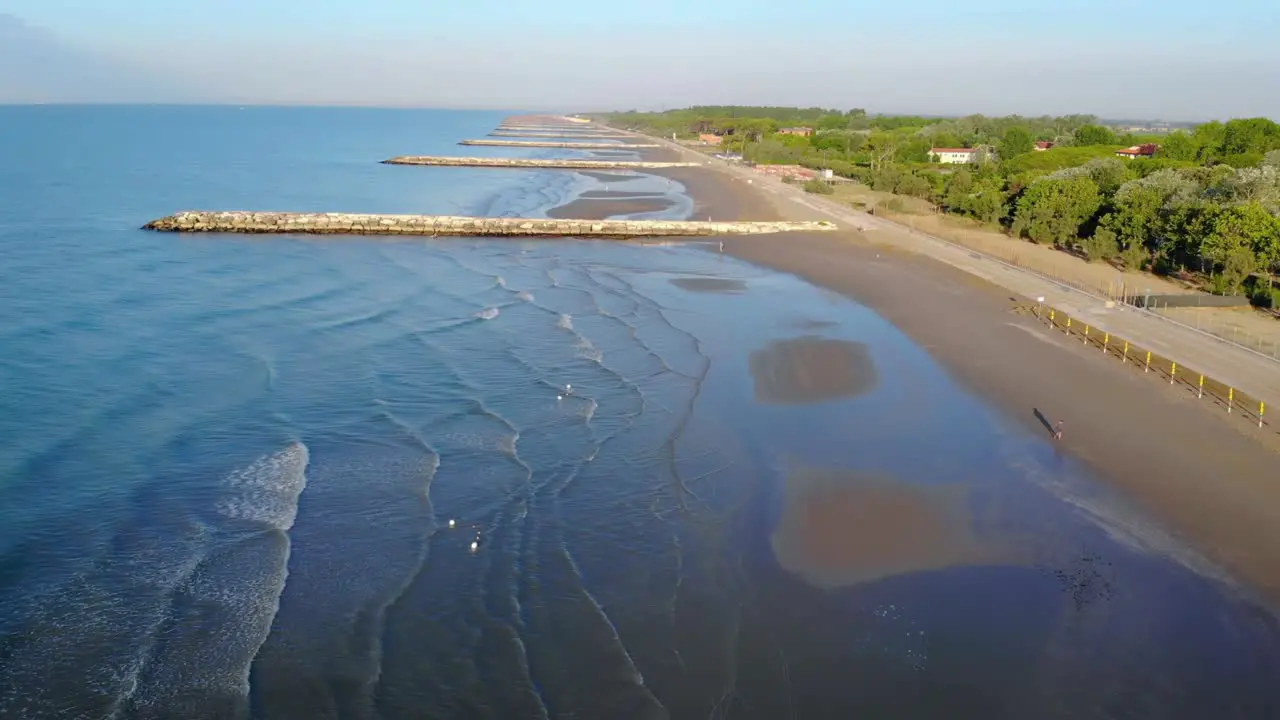 Drone aerial shot flying over a beautiful beach in the Adriatic Sea Italy