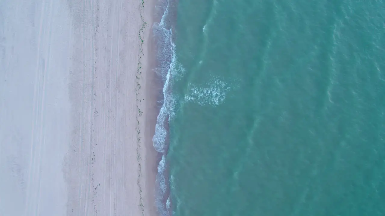 Aerial view of North Sea towards white sand beach at sunset