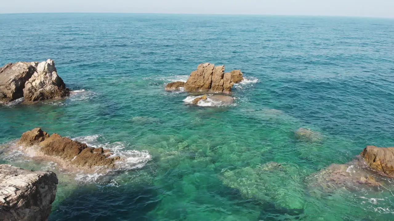 Drone fly over sea rocks beach Mourtitza Greece