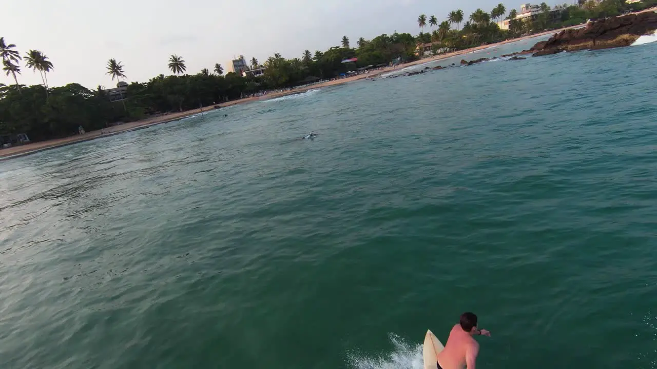 Cinematic view of a beach where People are running water ski