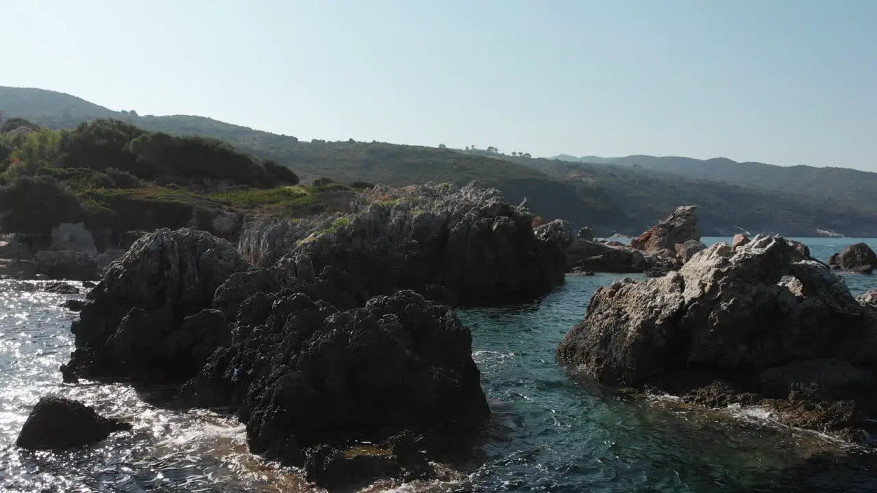 Drone parallel flight over rocks at the Morurtitza beach Greece