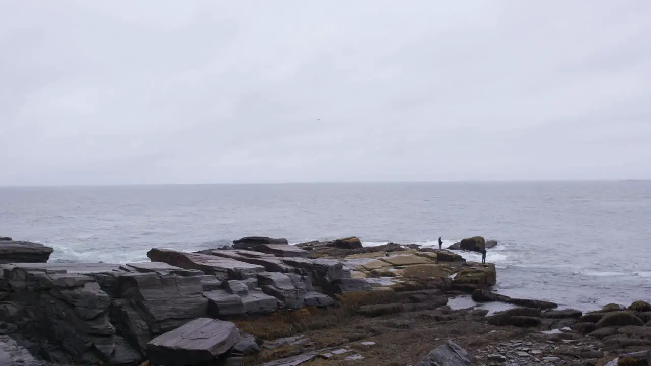 Men Fishing Off Rocks During Storm-1