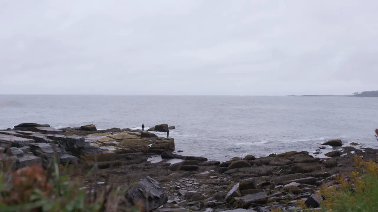 Men Fishing Off Rocks During Storm