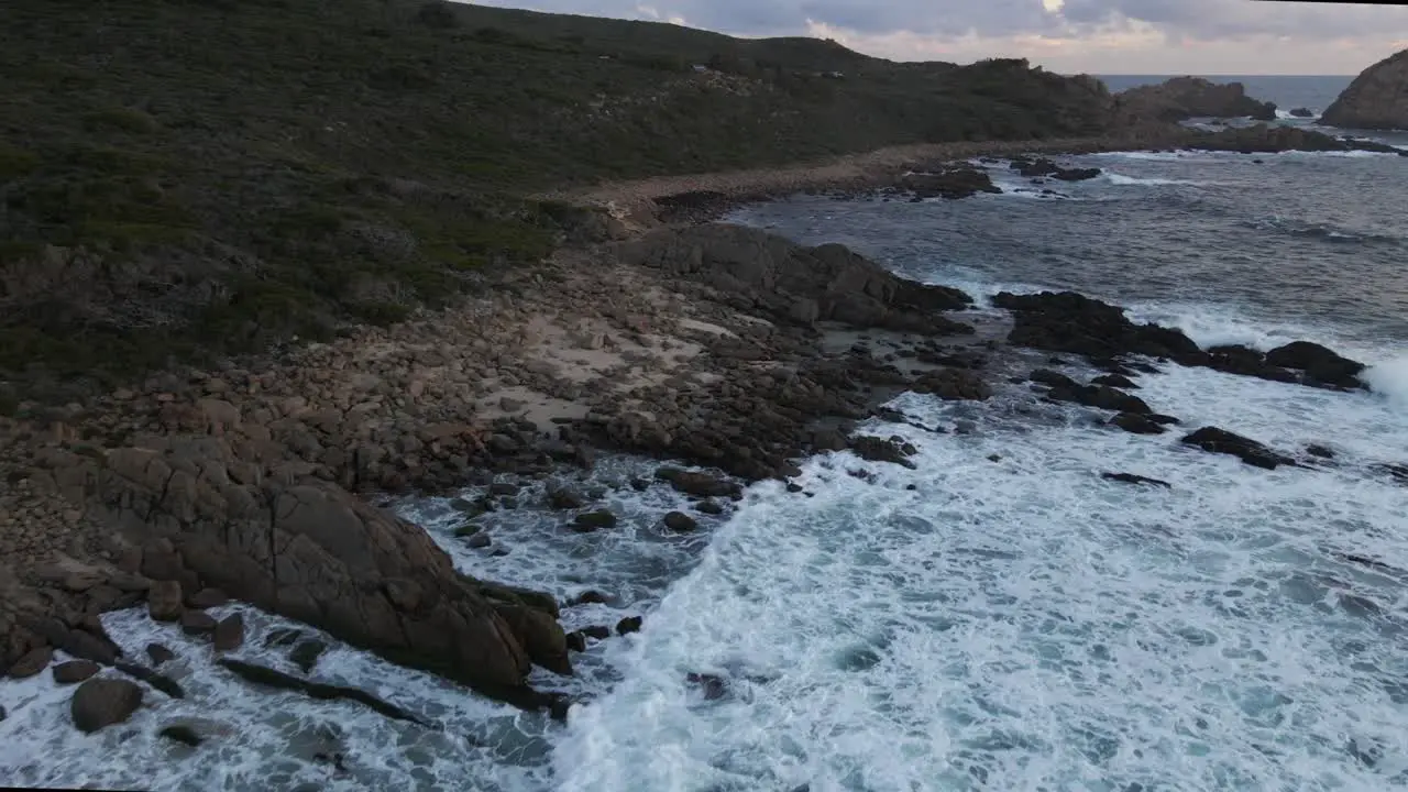 A dynamic aerial footage moving along the shorelines with various waves hitting the seashore