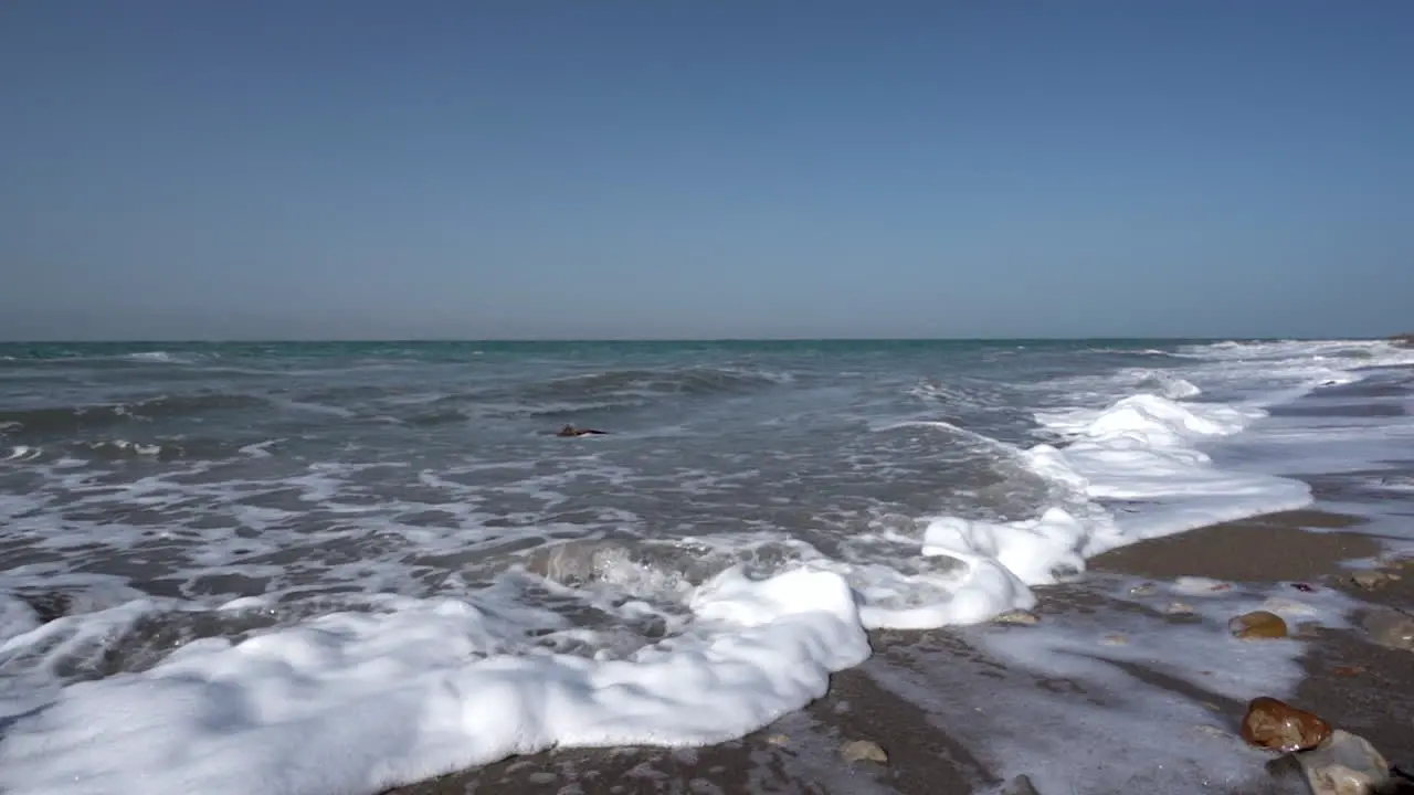 A Blue and Clear Sky Above The Crashing Waves of Dead Sea in Slow Motion in 100 Frames Per Second