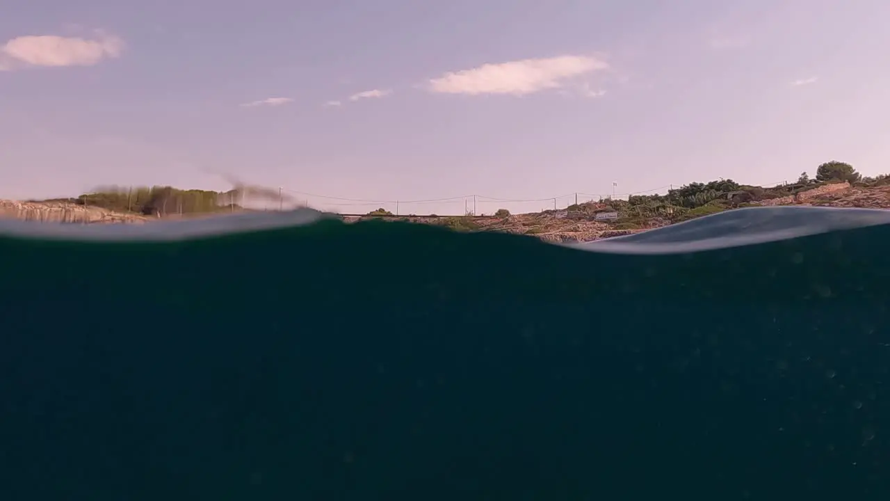 Slow motion half underwater scenery of Ionian coast and cliffs of Salento in Apulia region Italy