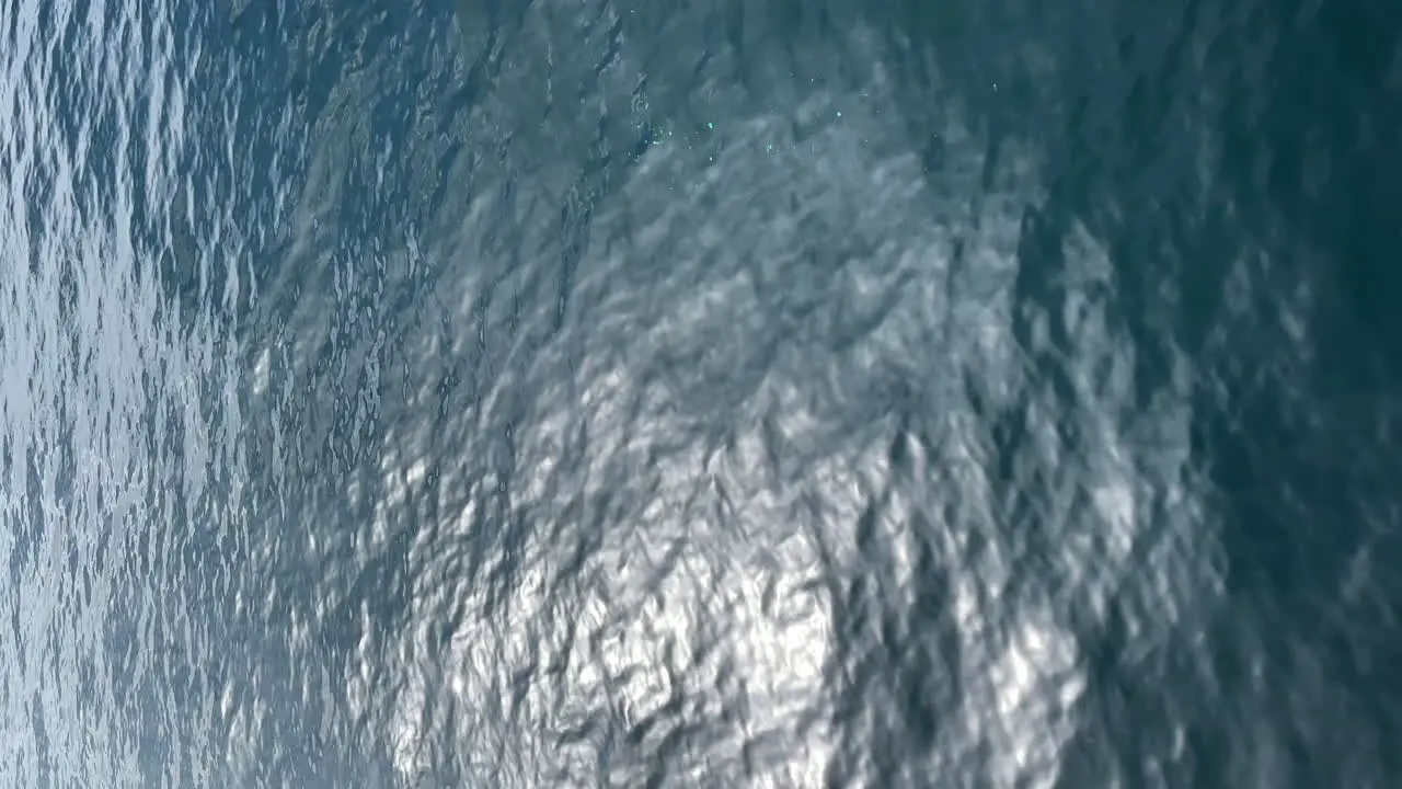 Looking at the surface of the ocean from a passing boat cruise ship or ferry vertical orientation